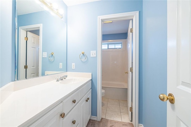 bathroom with toilet, vanity, and tile patterned flooring