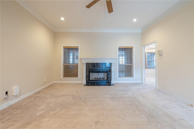 unfurnished living room with ornamental molding, light carpet, a tile fireplace, and ceiling fan