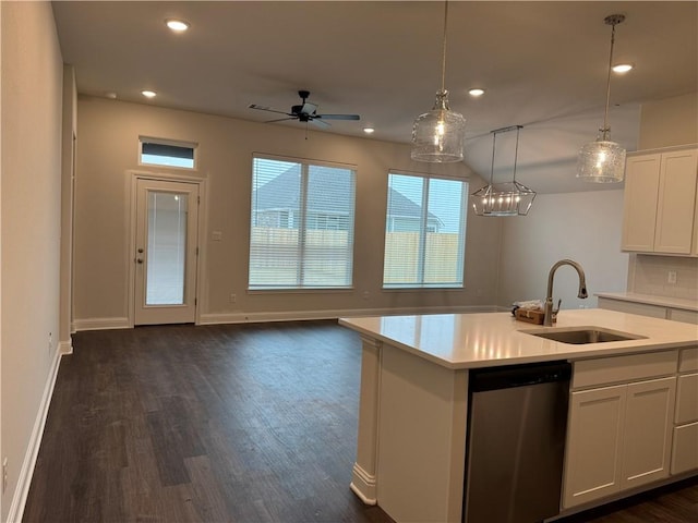 kitchen featuring sink, white cabinetry, a kitchen island with sink, decorative light fixtures, and stainless steel dishwasher