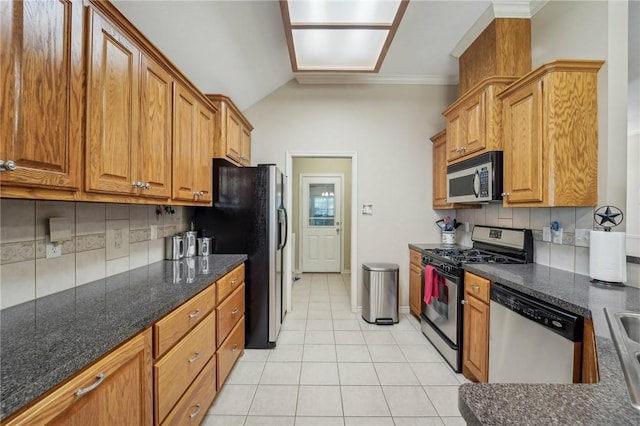 kitchen with stainless steel appliances, backsplash, dark stone countertops, vaulted ceiling, and light tile patterned floors