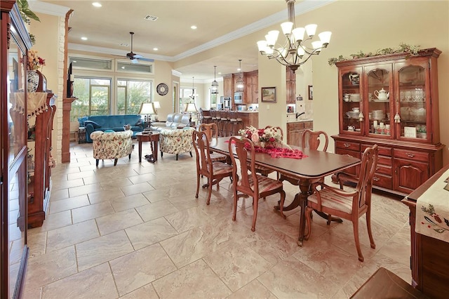 dining room featuring crown molding and ceiling fan with notable chandelier