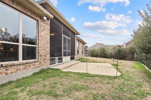 view of yard featuring a sunroom and a patio area