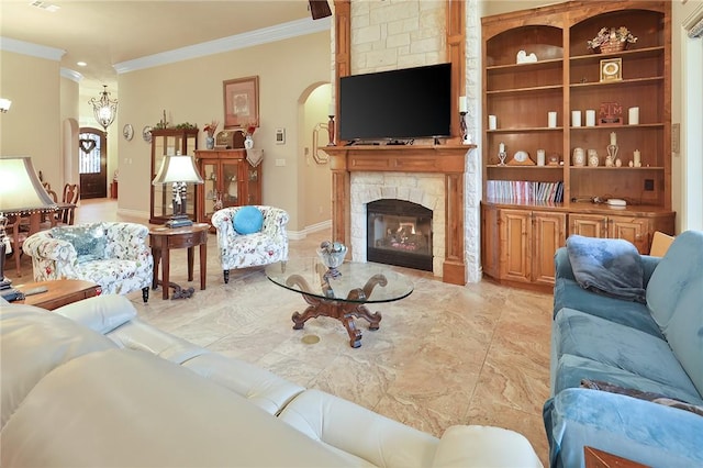 living room featuring crown molding, a fireplace, and built in features