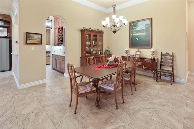 dining area with crown molding and a chandelier