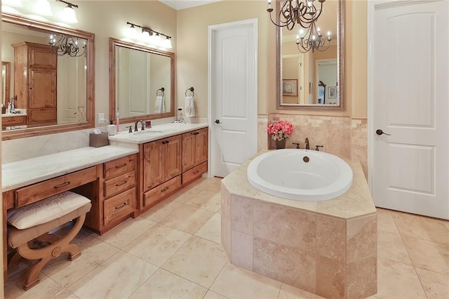 bathroom with tile patterned flooring, vanity, tiled tub, and a chandelier