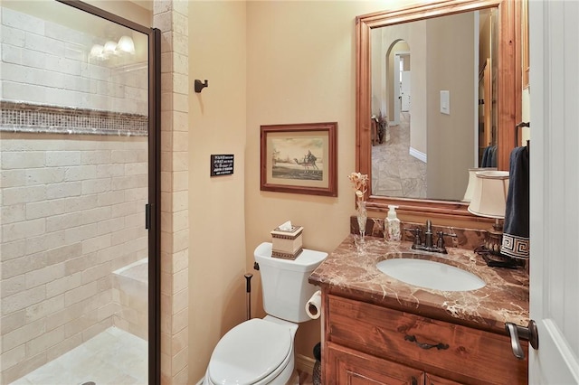 bathroom with vanity, an enclosed shower, and toilet