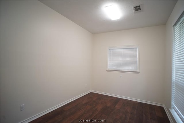 unfurnished room featuring dark wood-type flooring