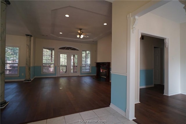 foyer entrance with a tray ceiling, ceiling fan, french doors, and light wood-type flooring