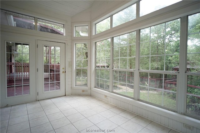 unfurnished sunroom featuring lofted ceiling