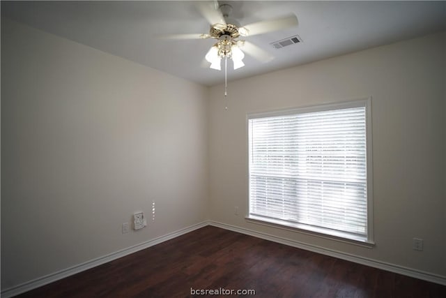 spare room featuring ceiling fan and dark wood-type flooring