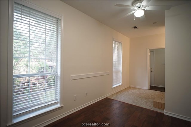 unfurnished room with hardwood / wood-style flooring and ceiling fan