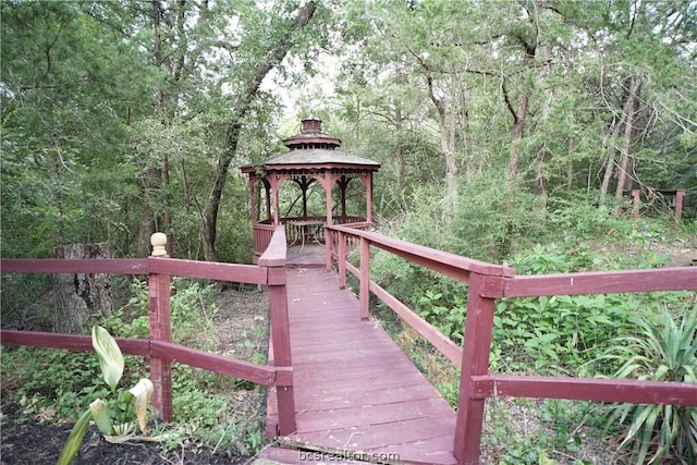 wooden terrace featuring a gazebo