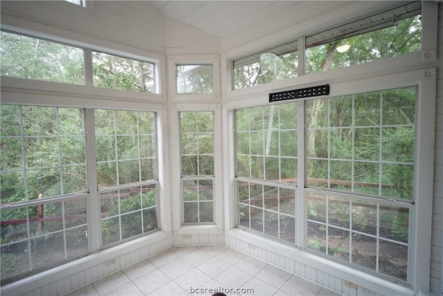 unfurnished sunroom featuring lofted ceiling