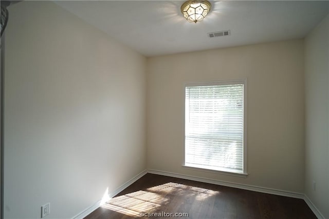 unfurnished room featuring dark hardwood / wood-style flooring