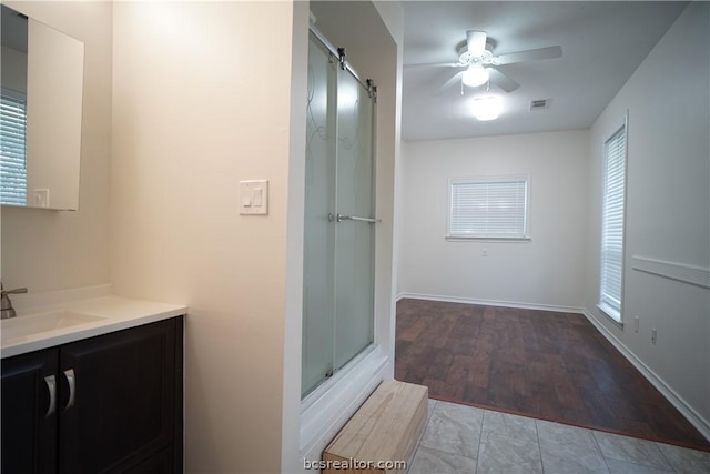 bathroom with hardwood / wood-style floors, vanity, and ceiling fan