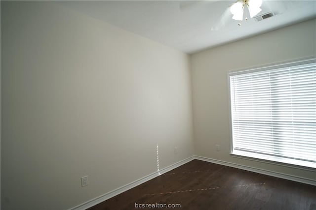 unfurnished room with ceiling fan and dark wood-type flooring