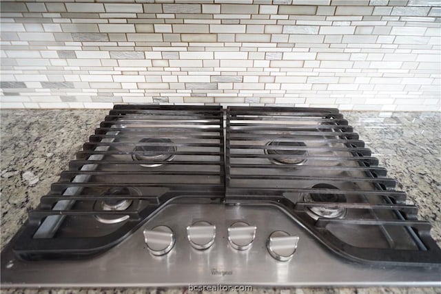 details with stone countertops and stainless steel gas cooktop