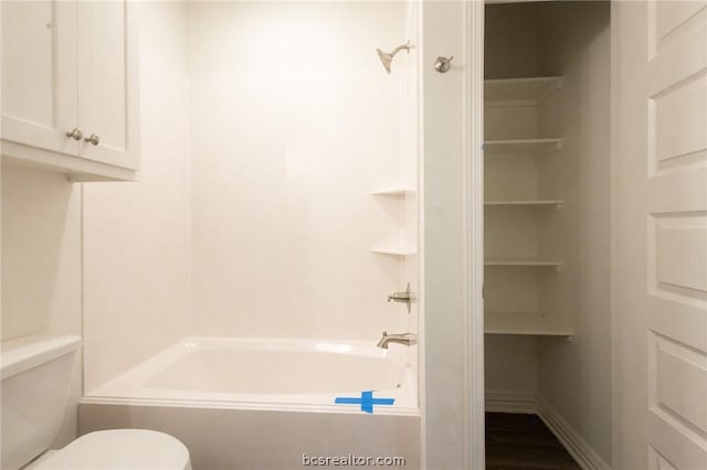 bathroom featuring shower / bath combination and toilet