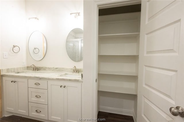 bathroom featuring hardwood / wood-style floors, vanity, and walk in shower