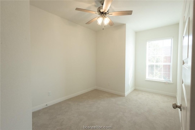 empty room featuring ceiling fan and light colored carpet