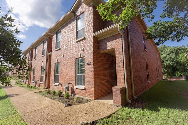 view of property exterior with a lawn