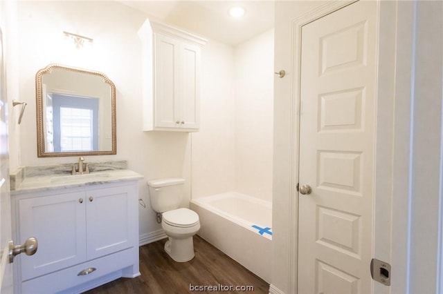 bathroom with vanity, toilet, and wood-type flooring