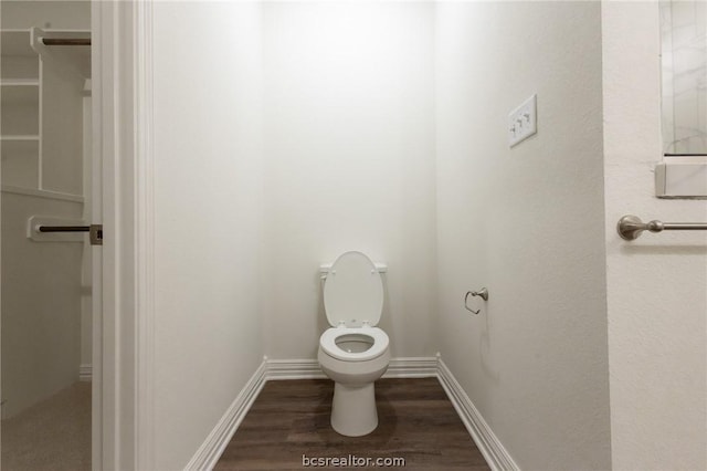 bathroom with hardwood / wood-style floors and toilet