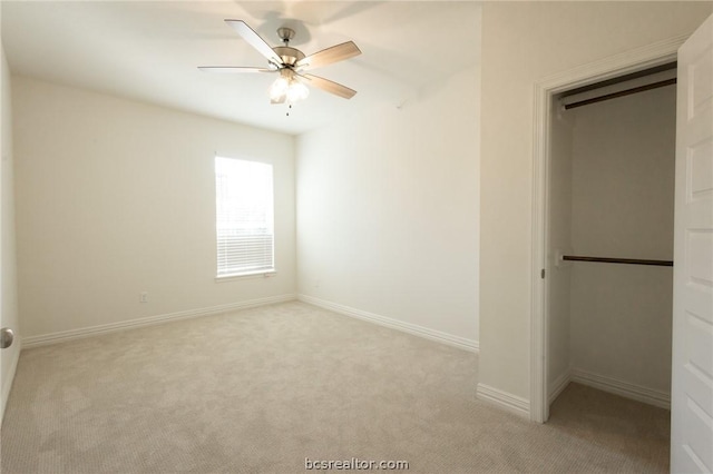 unfurnished bedroom featuring ceiling fan, light colored carpet, and a closet