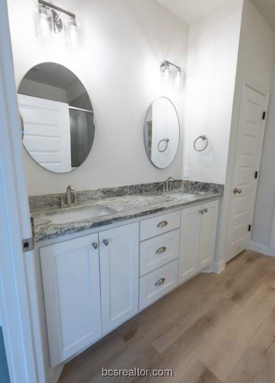 bathroom with hardwood / wood-style floors and vanity