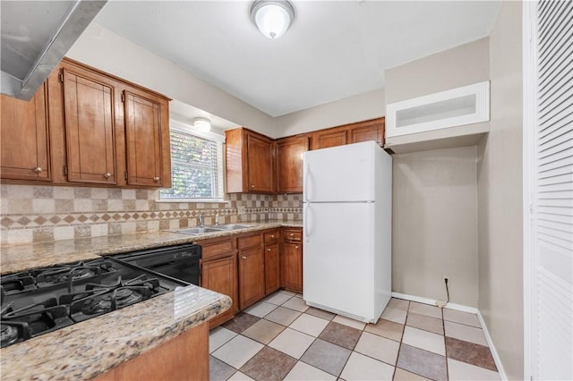 1214 Neal Pickett Dr, College Station, TX 77840 - kitchen with freestanding refrigerator, dishwasher, backsplash, and brown cabinetry