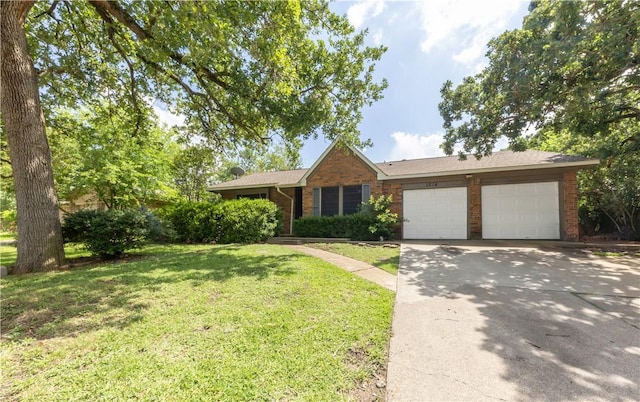 1214 Neal Pickett Dr, College Station, TX 77840 - ranch-style home featuring a garage, a front lawn, driveway, and brick siding