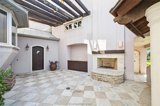 view of patio / terrace with an outdoor stone fireplace