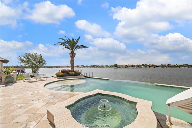 view of swimming pool with a water view, an in ground hot tub, and a patio