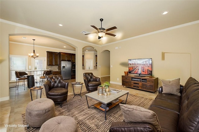 living room featuring crown molding and ceiling fan with notable chandelier