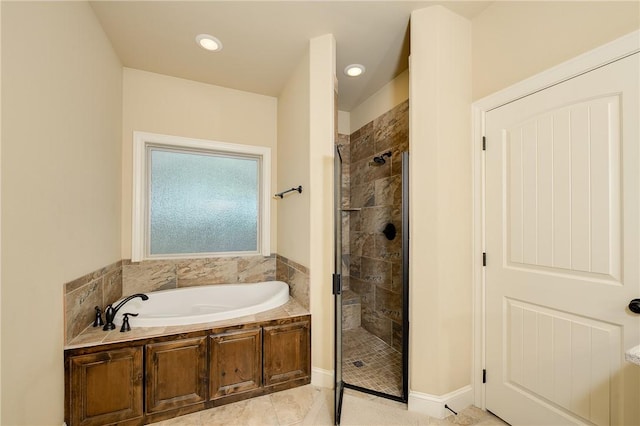 bathroom featuring plus walk in shower and tile patterned flooring