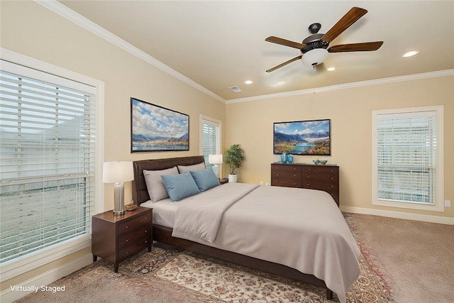 bedroom with crown molding, ceiling fan, and carpet