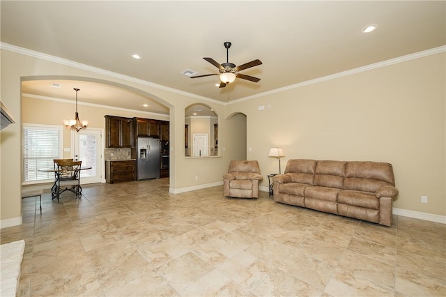 living room featuring crown molding and ceiling fan with notable chandelier