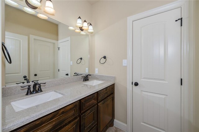 bathroom featuring vanity and a chandelier