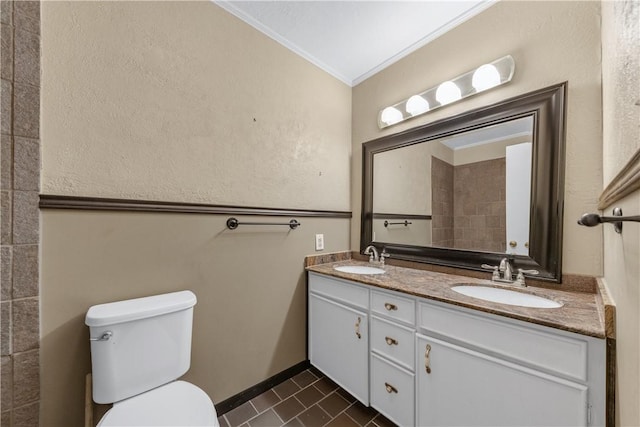 bathroom with tile patterned floors, vanity, toilet, and crown molding