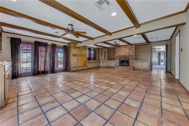 unfurnished living room featuring ceiling fan, a brick fireplace, built in features, beamed ceiling, and light tile patterned flooring