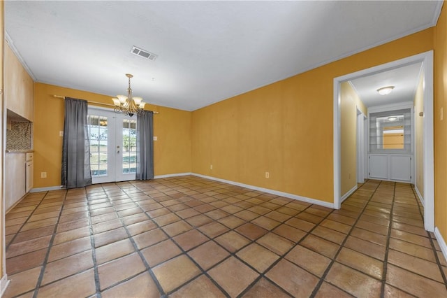 interior space with crown molding, french doors, a chandelier, and dark tile patterned flooring