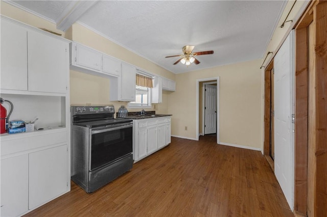 kitchen featuring electric range, white cabinets, and dark wood-type flooring