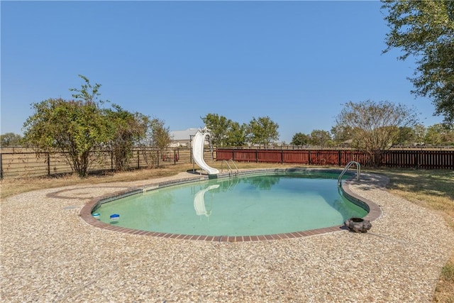 view of swimming pool featuring a water slide