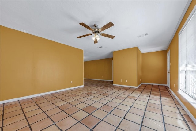 spare room with ceiling fan and light tile patterned floors