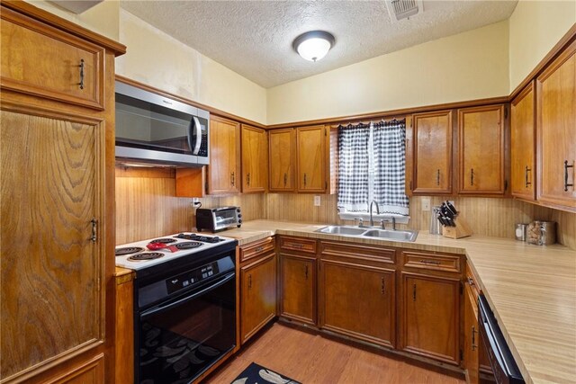 10072 Riley Green Rd, Franklin, TX 77856 - kitchen with stainless steel microwave, black electric range oven, a textured ceiling, light countertops, and dishwashing machine