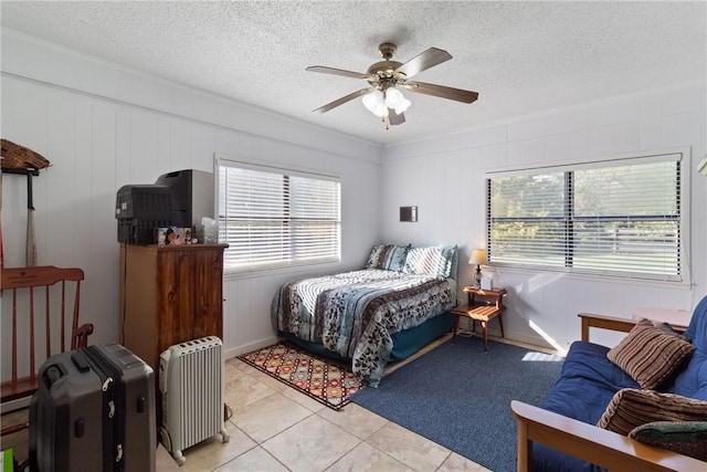 10072 Riley Green Rd, Franklin, TX 77856 - bedroom featuring light tile patterned flooring, a textured ceiling, and a ceiling fan