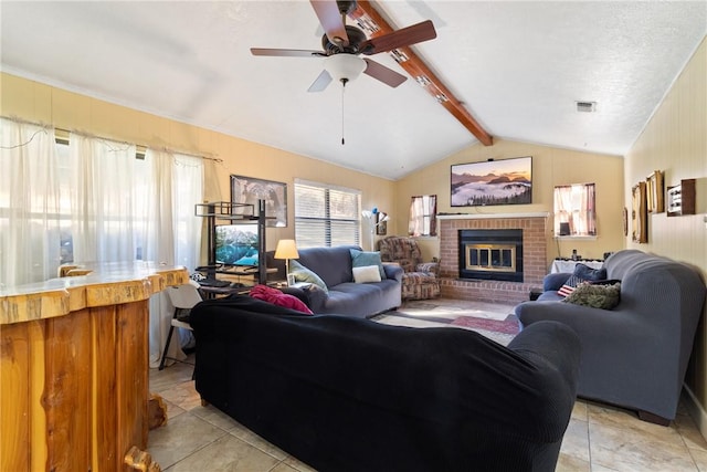 10072 Riley Green Rd, Franklin, TX 77856 - living room with a fireplace, ceiling fan, and light tile patterned flooring