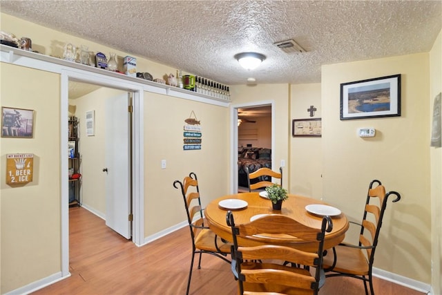 10072 Riley Green Rd, Franklin, TX 77856 - dining area featuring light wood-style floors and a textured ceiling