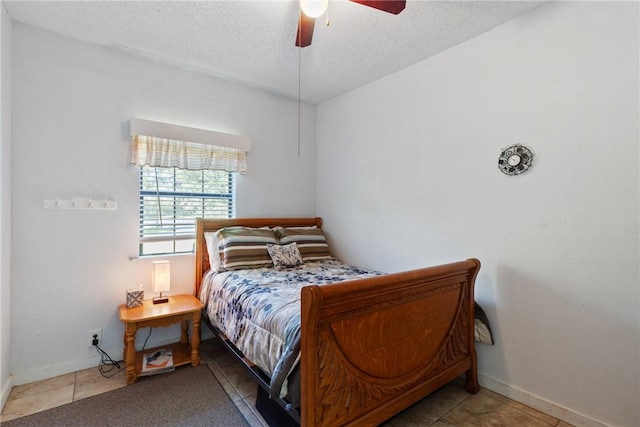 10072 Riley Green Rd, Franklin, TX 77856 - bedroom featuring a textured ceiling, tile patterned flooring, and ceiling fan