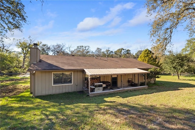 back of property featuring a patio area and a yard